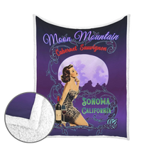 Sonoma Rebel Moon Mountain Cabernet Sauvignon pinup fleece blanket with sherpa lining, featuring a vintage style woman, wine bottle, and moon.